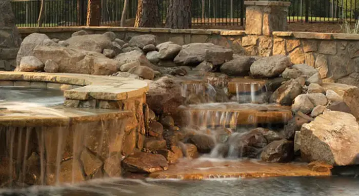 Small waterfall with water splashing and tumbling over the rocks